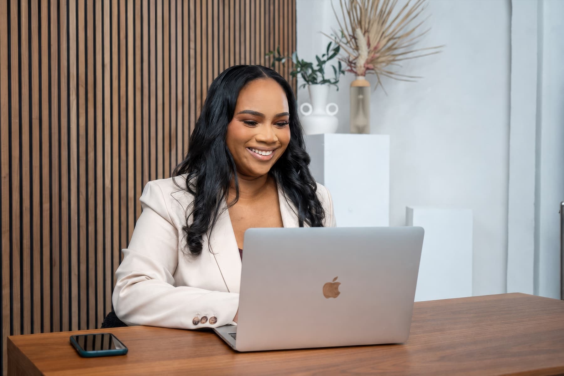 Tiffany Durham working at her desk on a laptop.